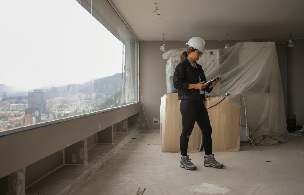 a woman looking at documents in a building site