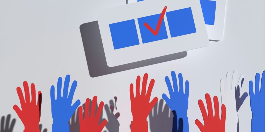 hands raised in the air and a box showing a tick to simulate participatory democracy