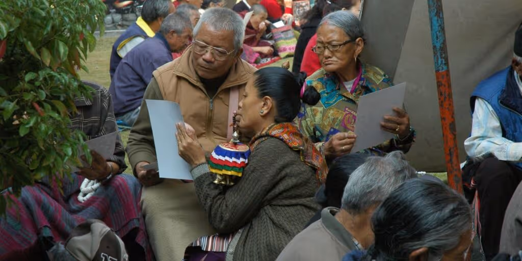 woman showing man something on a piece of paper as they publicly engage over a political issue