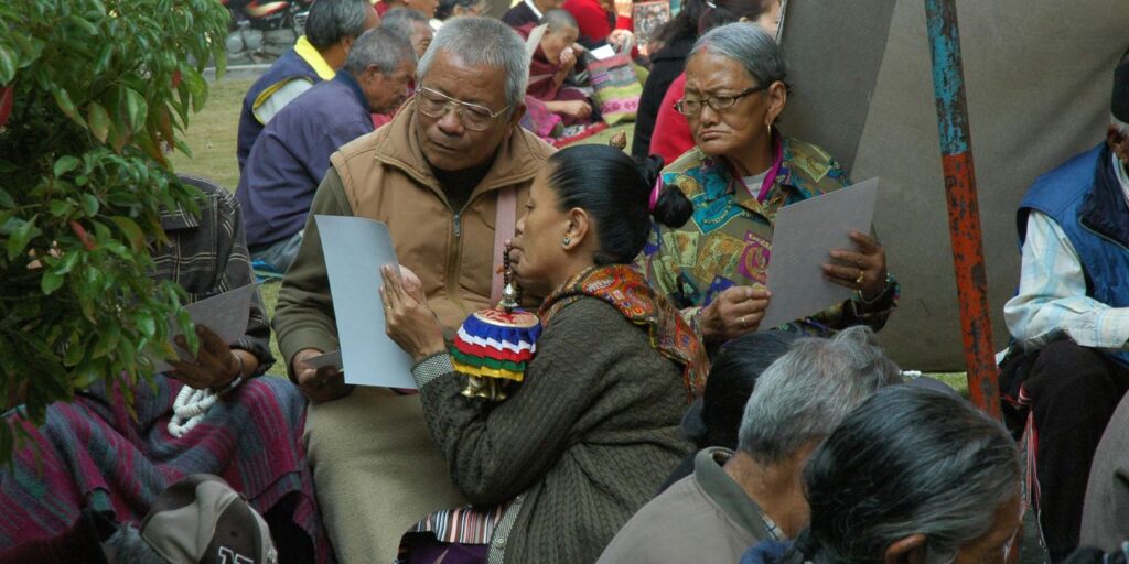 woman showing man something on a piece of paper as they publicly engage over a political issue