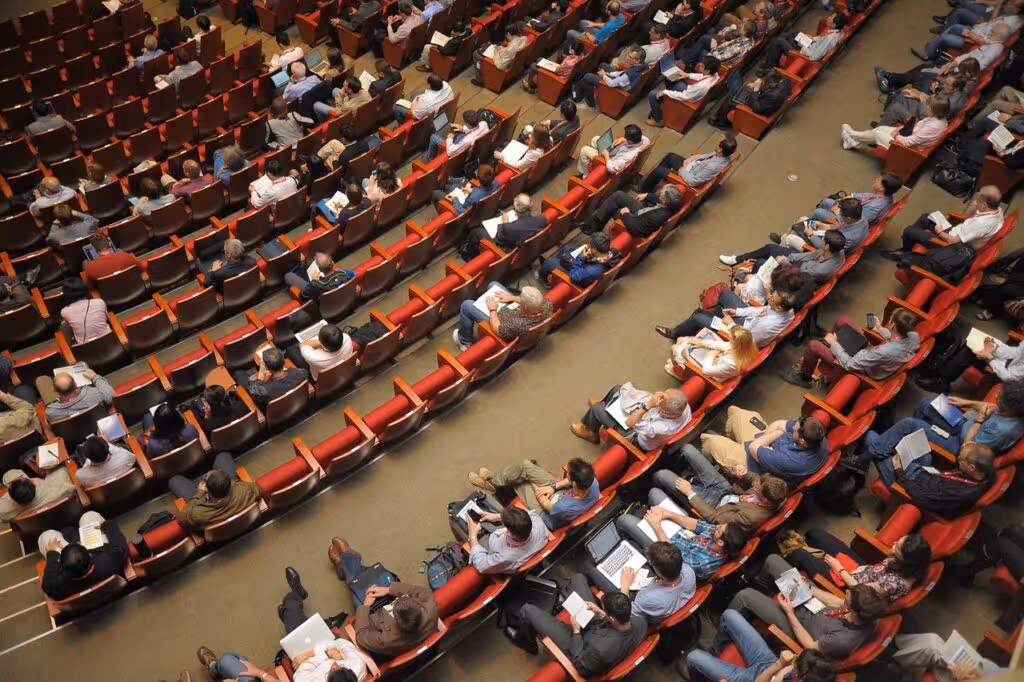 citizens assembly ,birds eye view looking down at people sat in theater ready to discuss