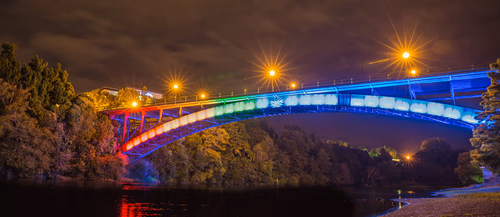 Hamilton Bridge in NZ lit up with LGBTQ colours