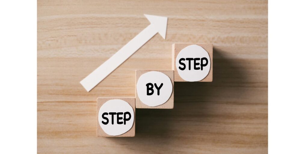 three blocks with the words step by step and an arrow pointing upward