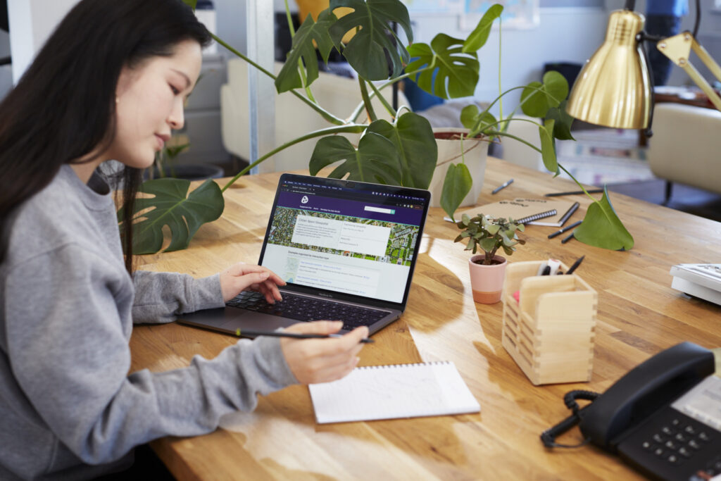 woman sat at desk with laptop open to Citizen Space page