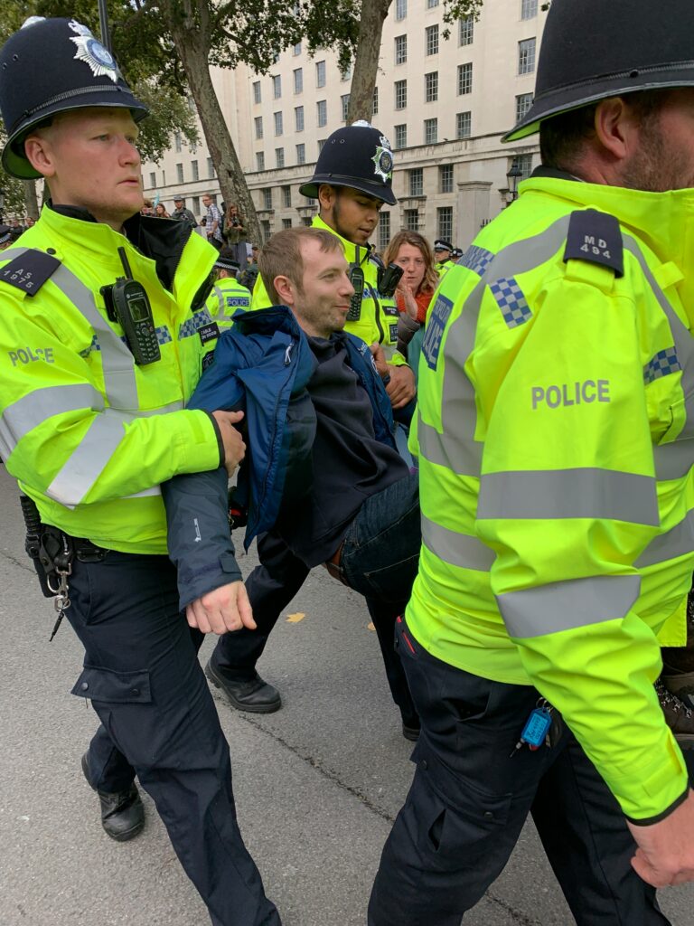 police officers carrying off a man who will be slapped with a respect order