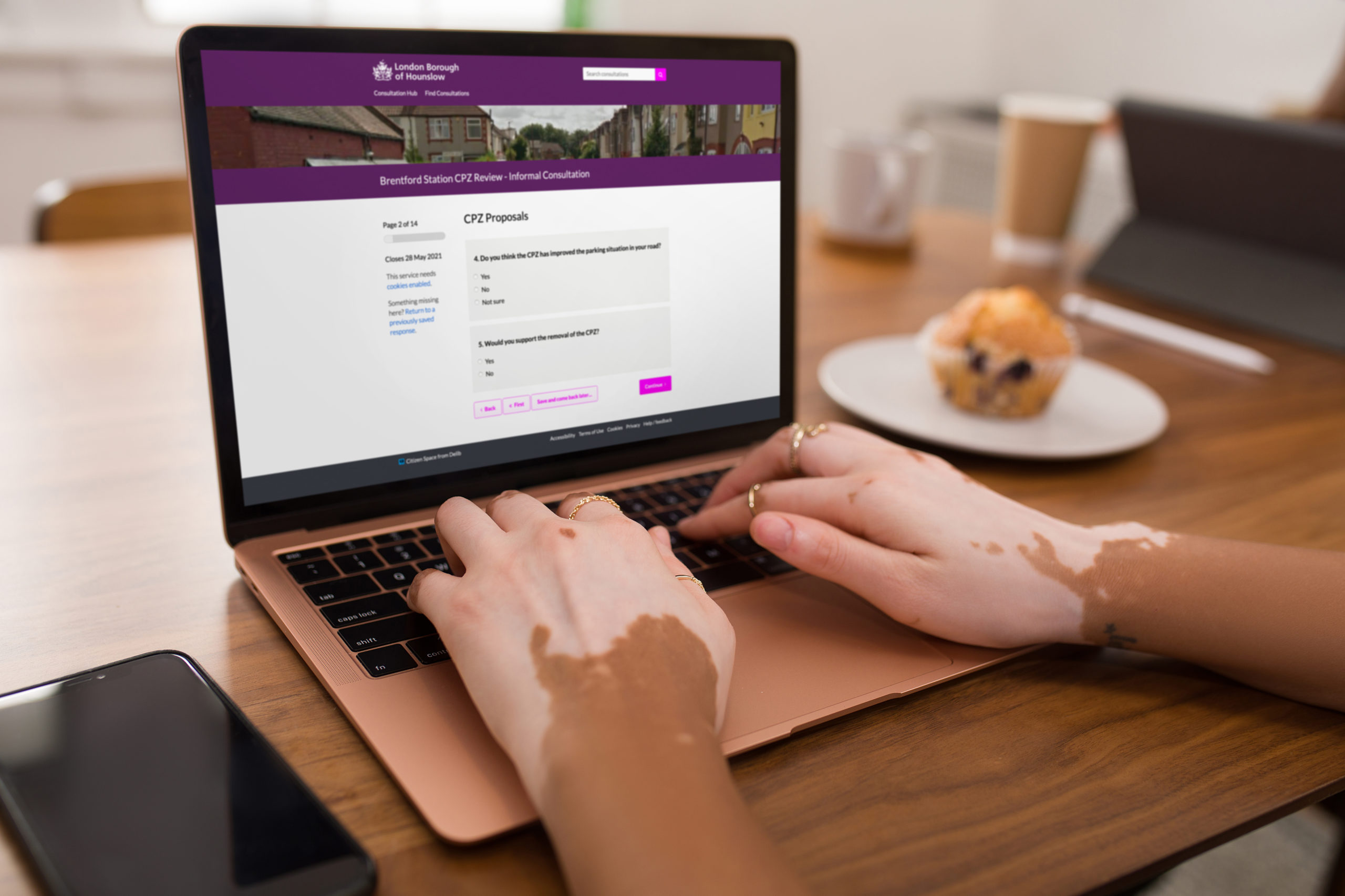 Woman's hands on a laptop displaying Hounslow's Brentford CPZ consultation