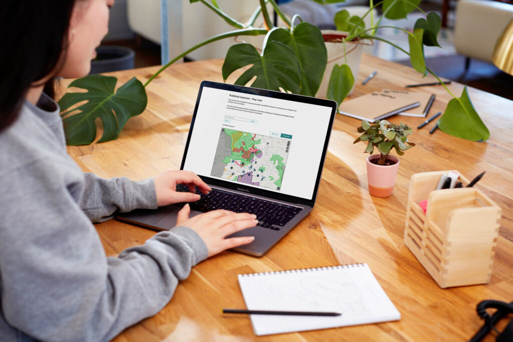 woman looking at CS Geospatial on laptop