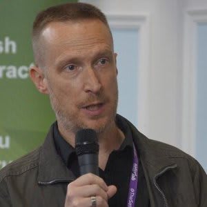 Dave Mckenna speaks into microphone