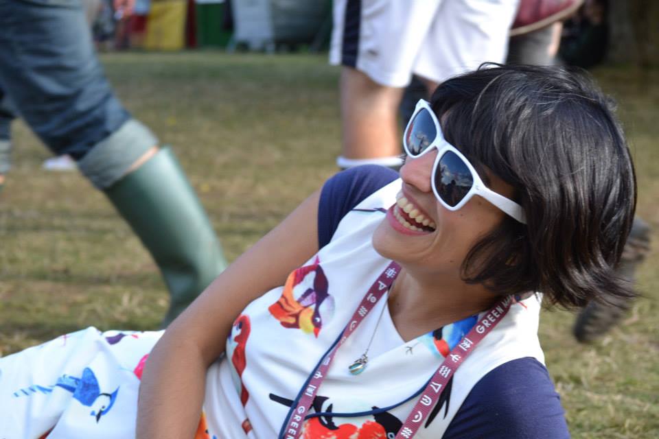 Woman lying on grass smiling 