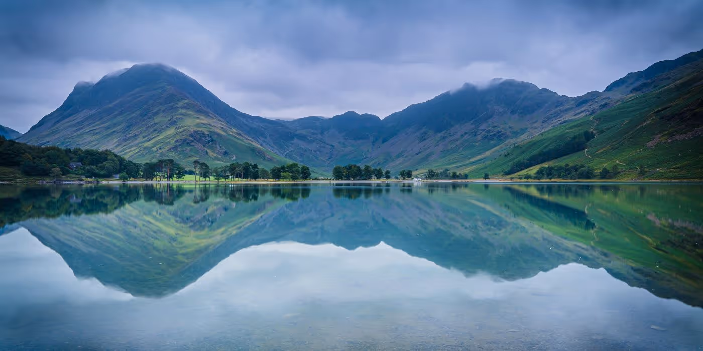 beautiful vista of rollin ghills over a body of water
