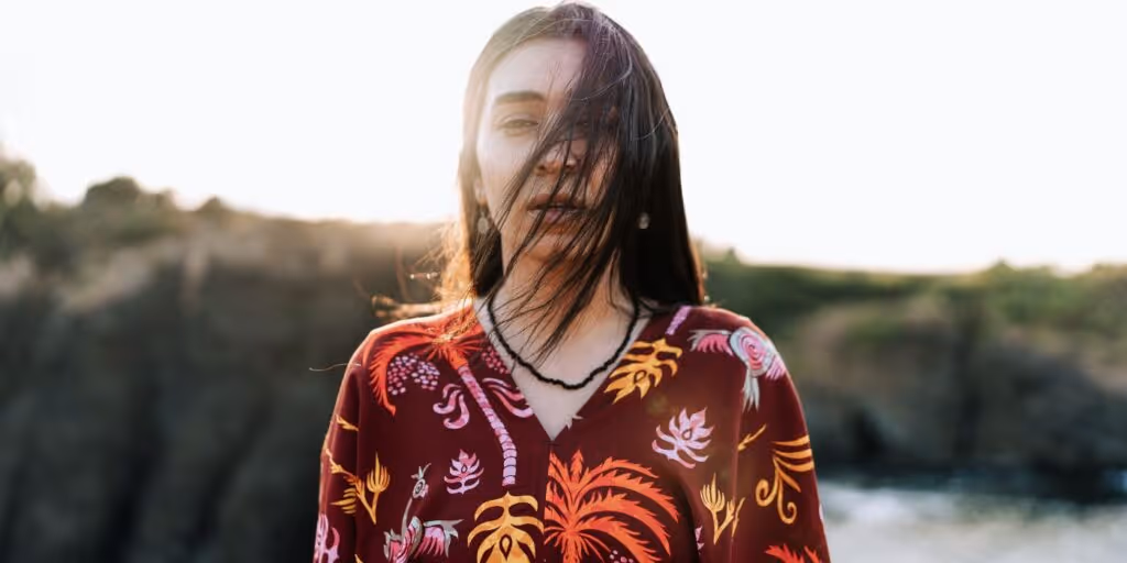indigenous woman stares straight at camera