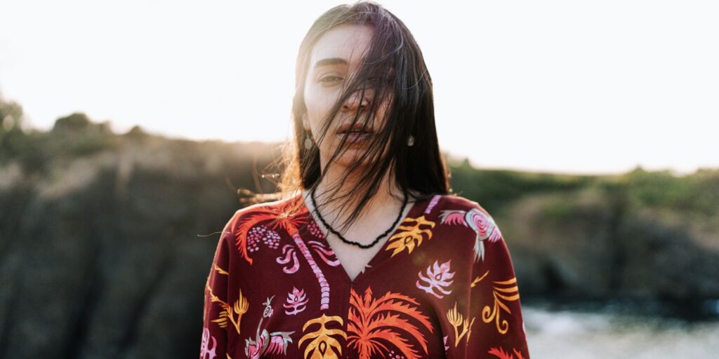 indigenous woman stares straight at camera