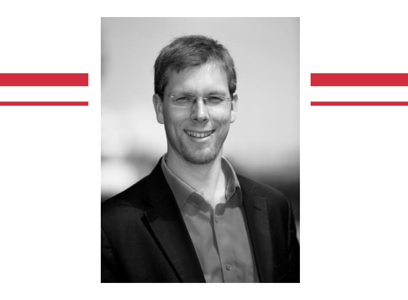 picture of jason kitkat smiling at camera in a shirt and blazer