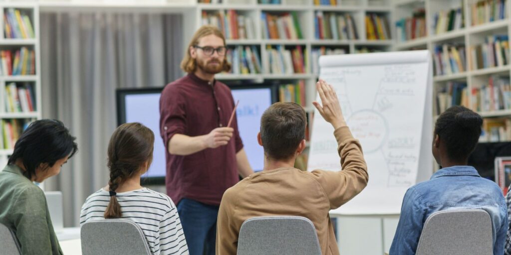group sat in front of a whiteboard discussing ideas