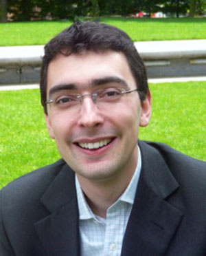 Photo of steph gray wearing a suit smiling at the camera