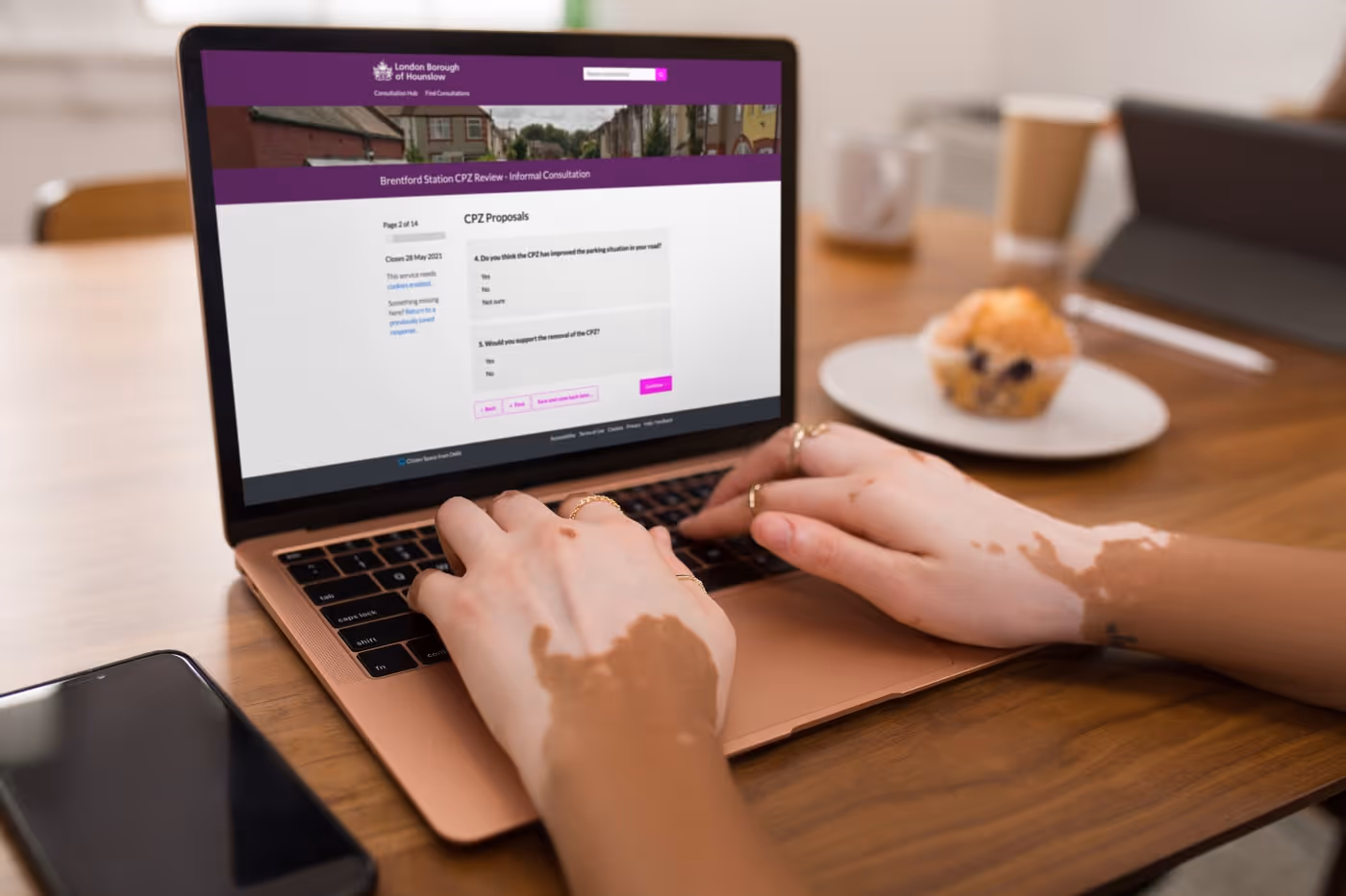 Woman's hands typing on a laptop displaying a Citizen Space consultation
