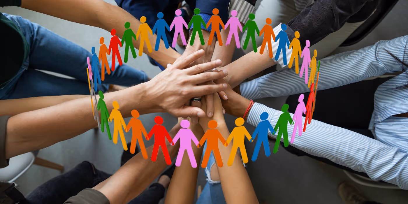 a collective group of hands all in the middle, placed upon each other
