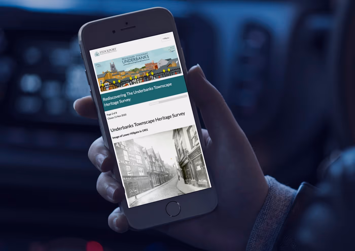 Hand holding an iPhone which displays Stockport's 'Rediscovering the Underbanks Townscape Heritage Survey'