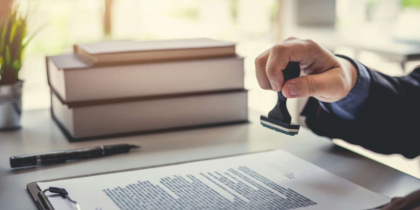 regulatory compliance demonstrated by someone with a gavel and legal notice