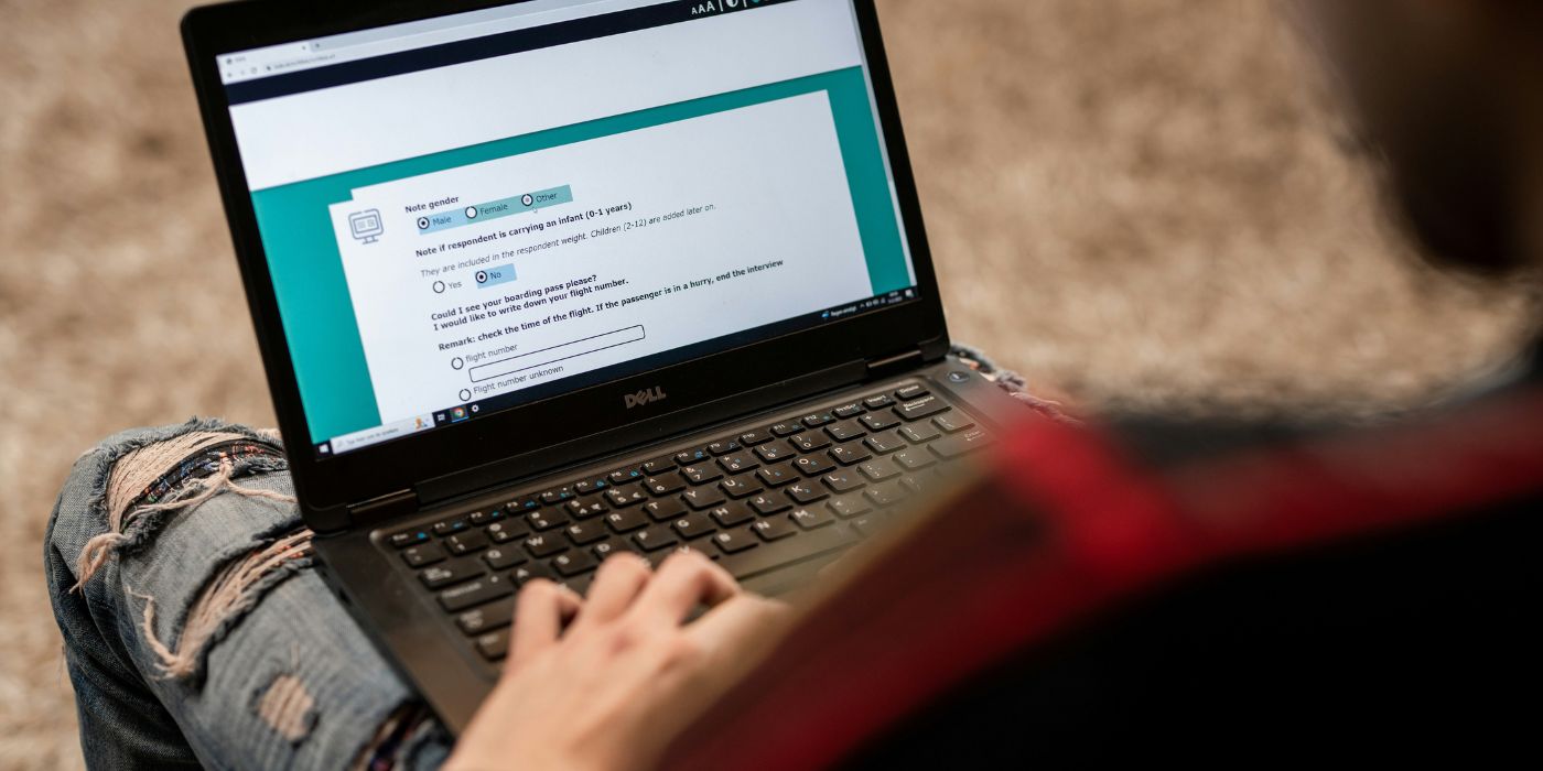 person looks down at survey on a laptop screen asking demographic questions