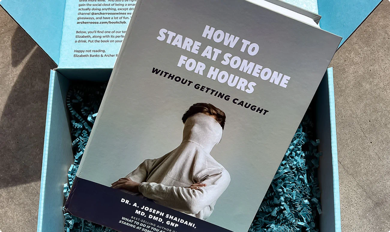 Influencer gift box for Archer Roose Wine created by Colossus. Featuring a faux book called "How to stare at someone for hours without getting caught."