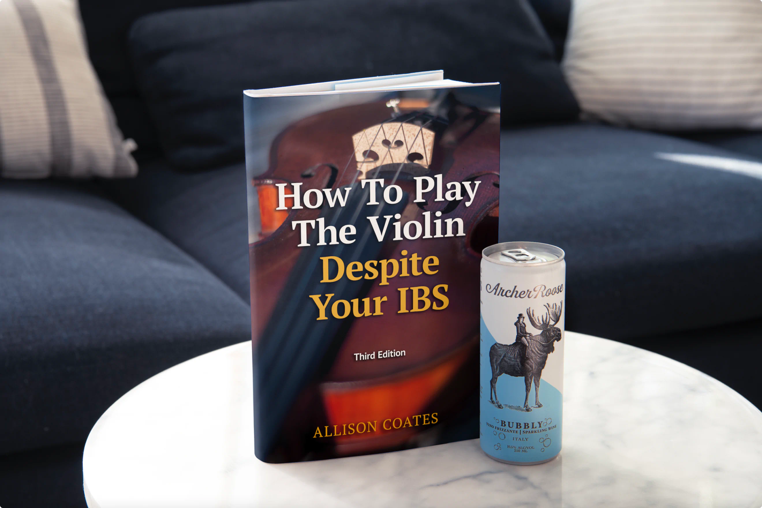 "How to Play The Violin Despite your IBS." Hardback book on display next to a can of Archer Roose Wine. A part of a clever ad campaign created by Colossus.