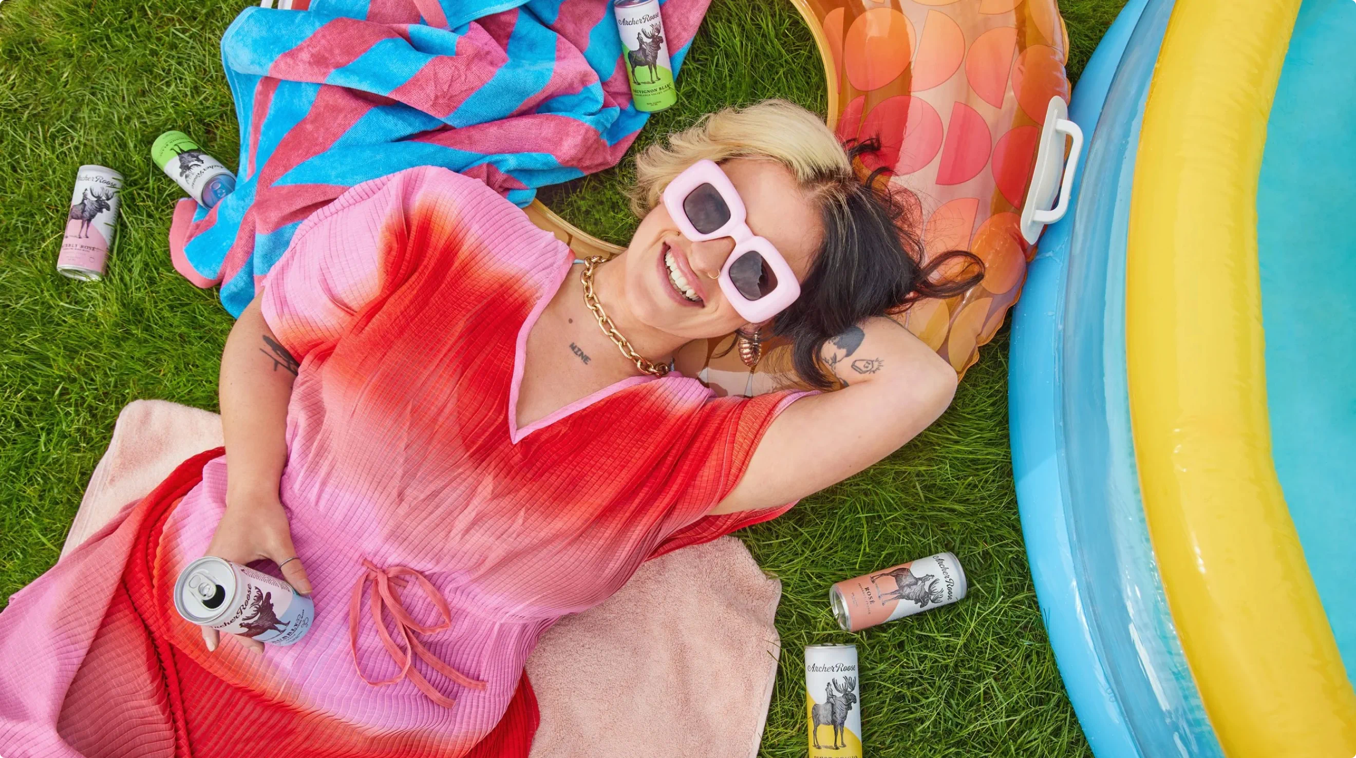 A woman lounging in the backyard grass. Part of the brand photography library developed for Archer Roose by Colossus.