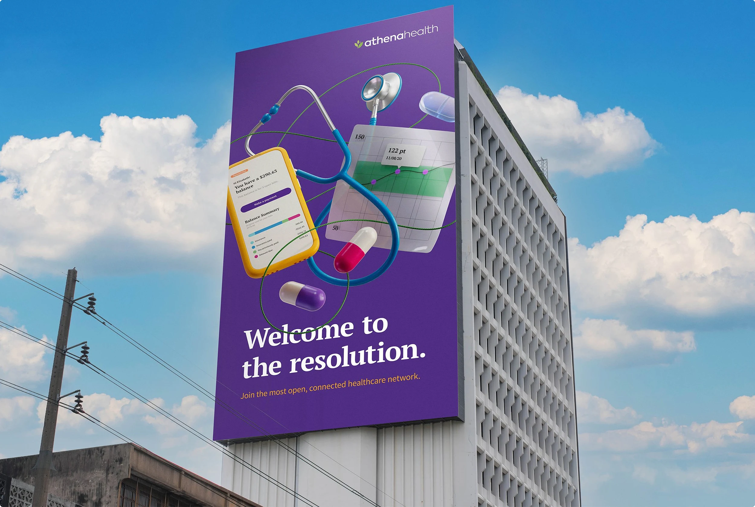 A large, downtown building with a multi-story billboard for athenahealth. the ad shows multiple healthcare icons floating in midair with the headline "Welcome to the resolution."