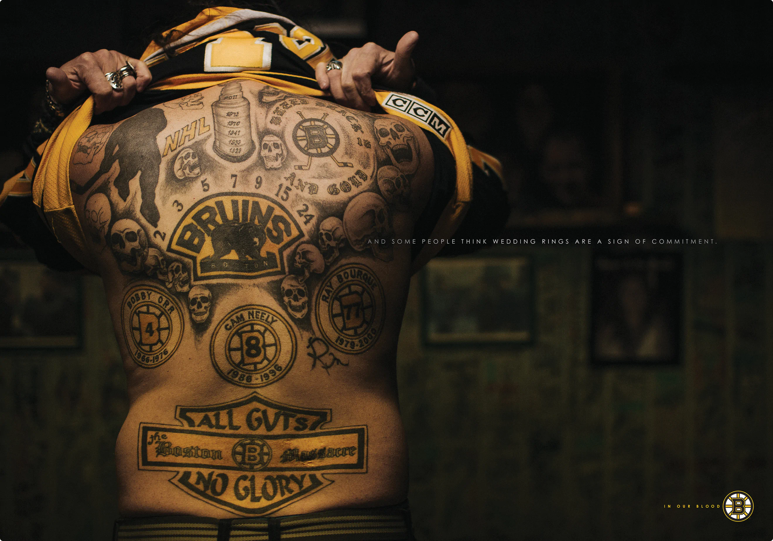 "In Our Blood" ad campaign print ad by Colossus. A picture of a full back tattoo featuring Bruins logos, Stanley Cups and more.