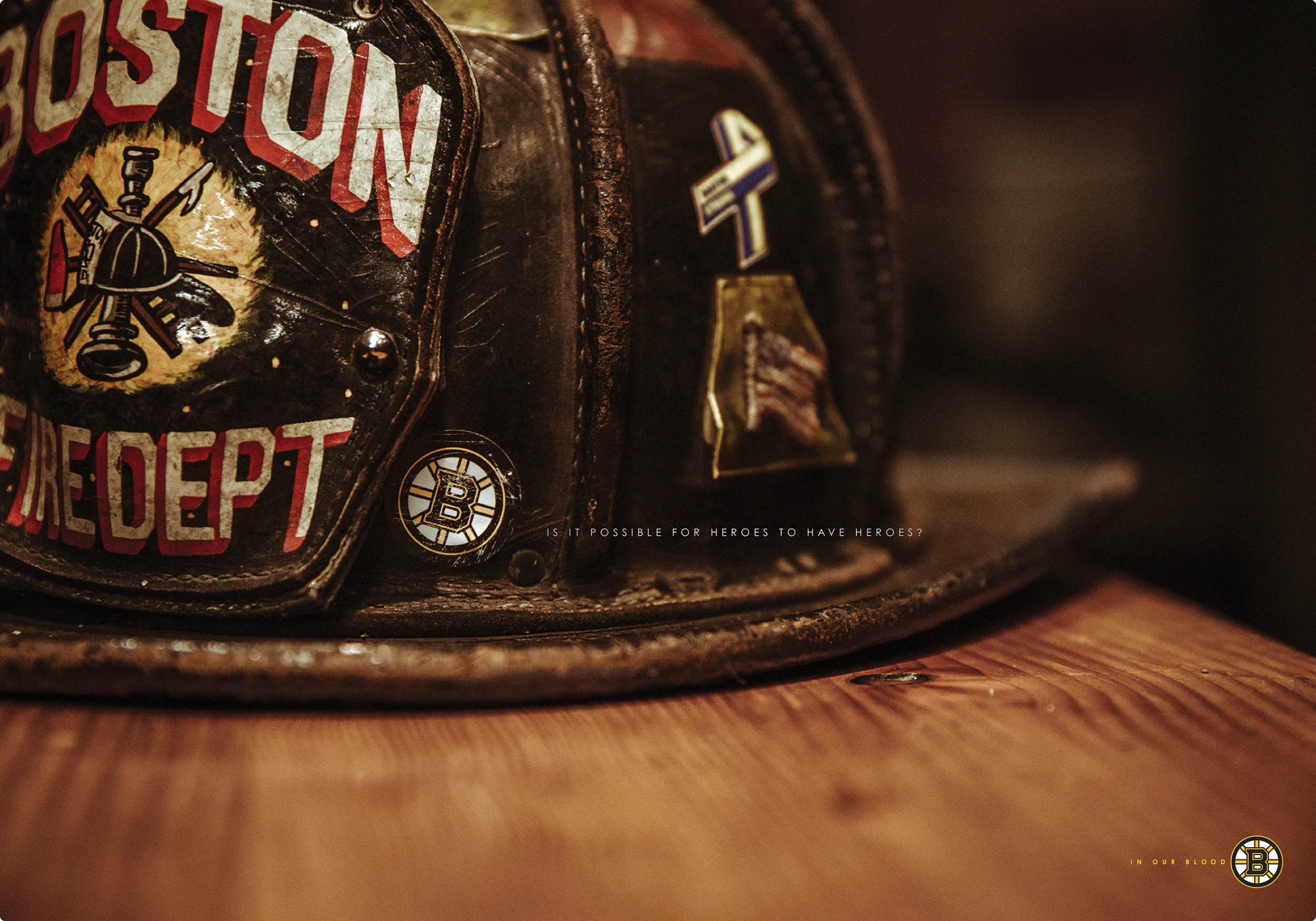 "In Our Blood" ad campaign print ad by Colossus. A picture of a Boston Fire Dept helmet with a Bruins sticker.