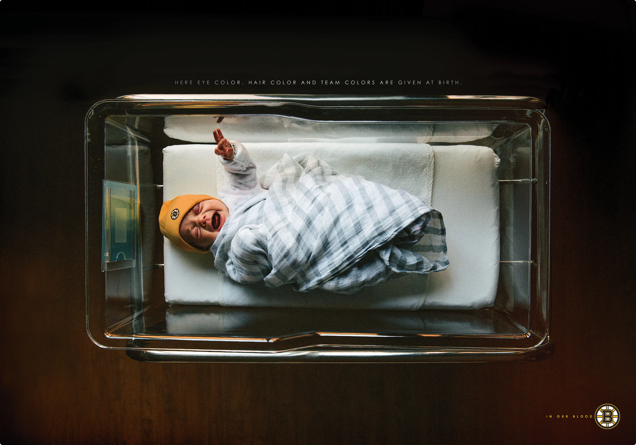 "In Our Blood" ad campaign print ad by Colossus. A picture of a newborn baby in a Bruins hat.