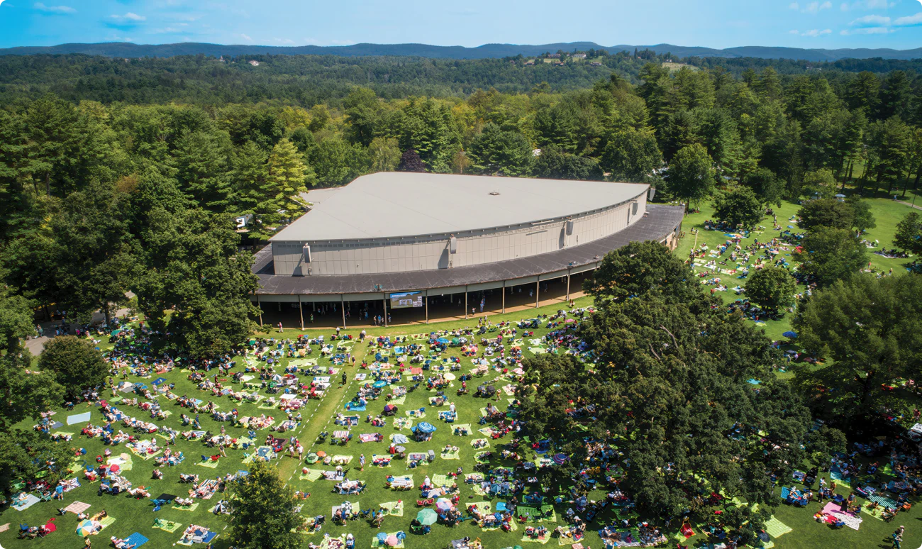 Large trees surround the Koussevitzky Music Shed in the green hills of Lenox. Tanglewood. The summer home of the Boston Symphony Orchestra.