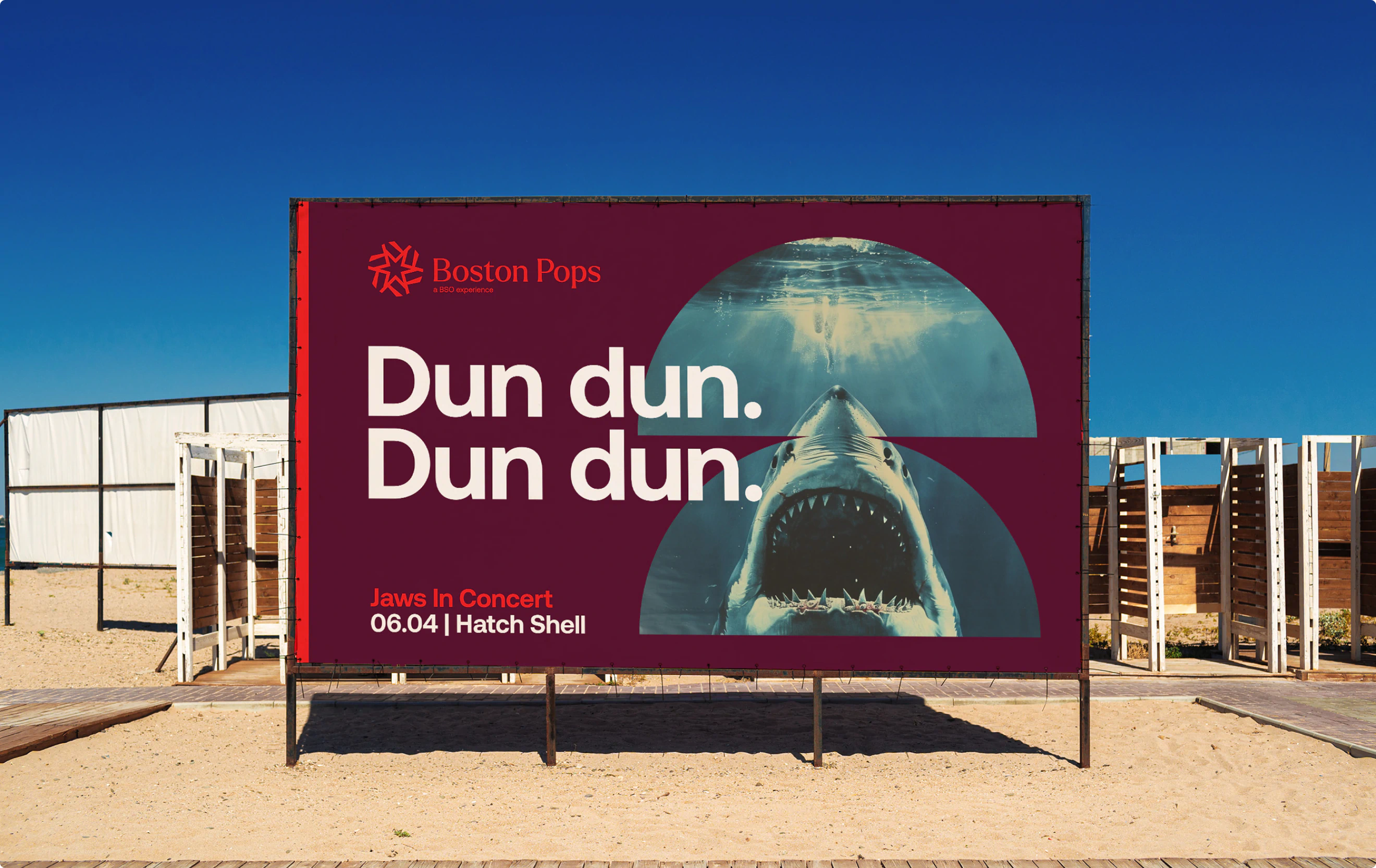 A billboard for the Boston Pops performance of "Jaws" featuring a large shark beneath the water surface and the headline "Dun dun. Dun dun." The design is a part of the BSO Brand Identity designed by Colossus Creative Co.