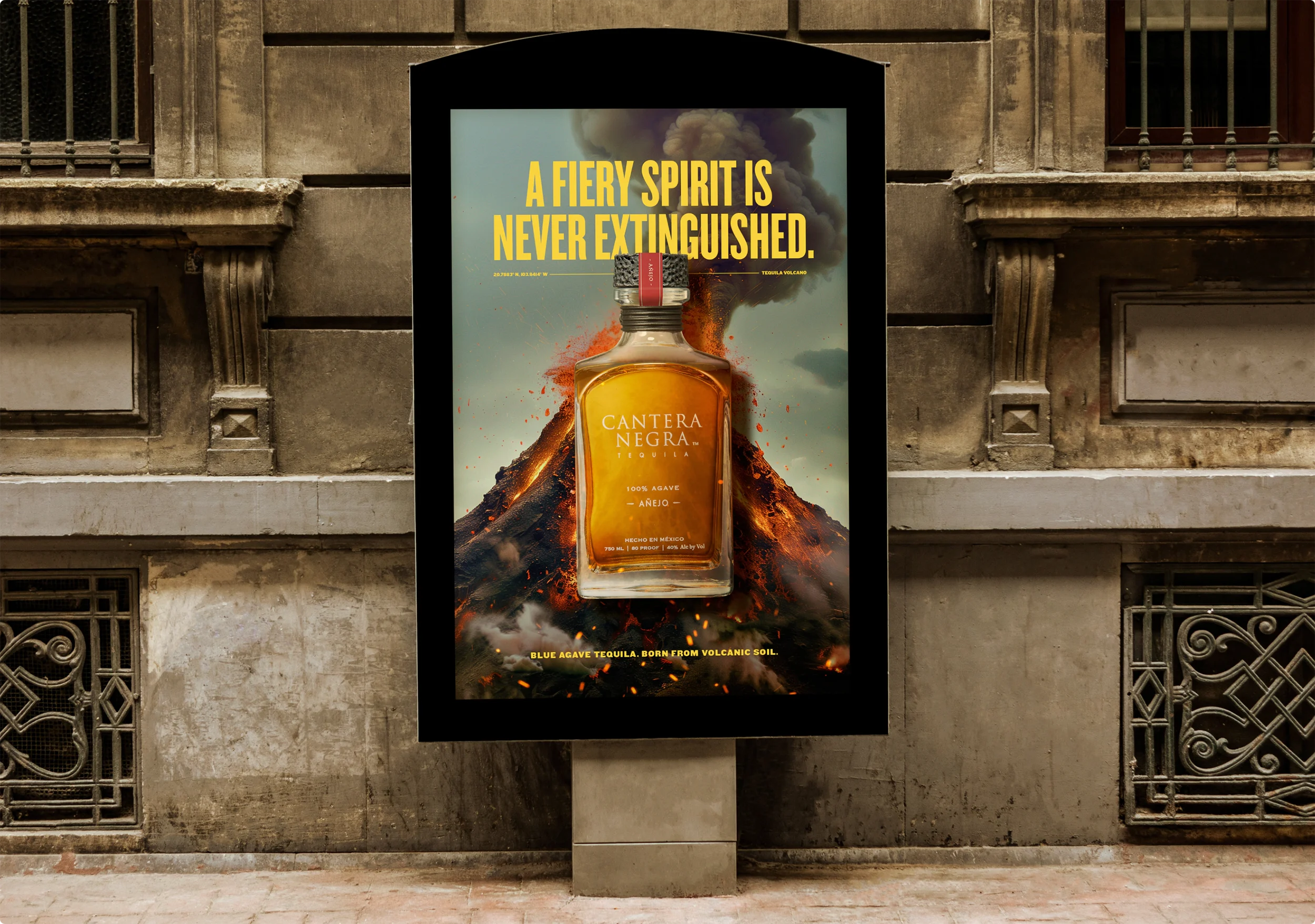 A street level, city advertisment for Cantera Negra. The ad shows a bottle of Cantera in front of an erupting volcano. The headline reads: "A fiery spirit is never extinguished."