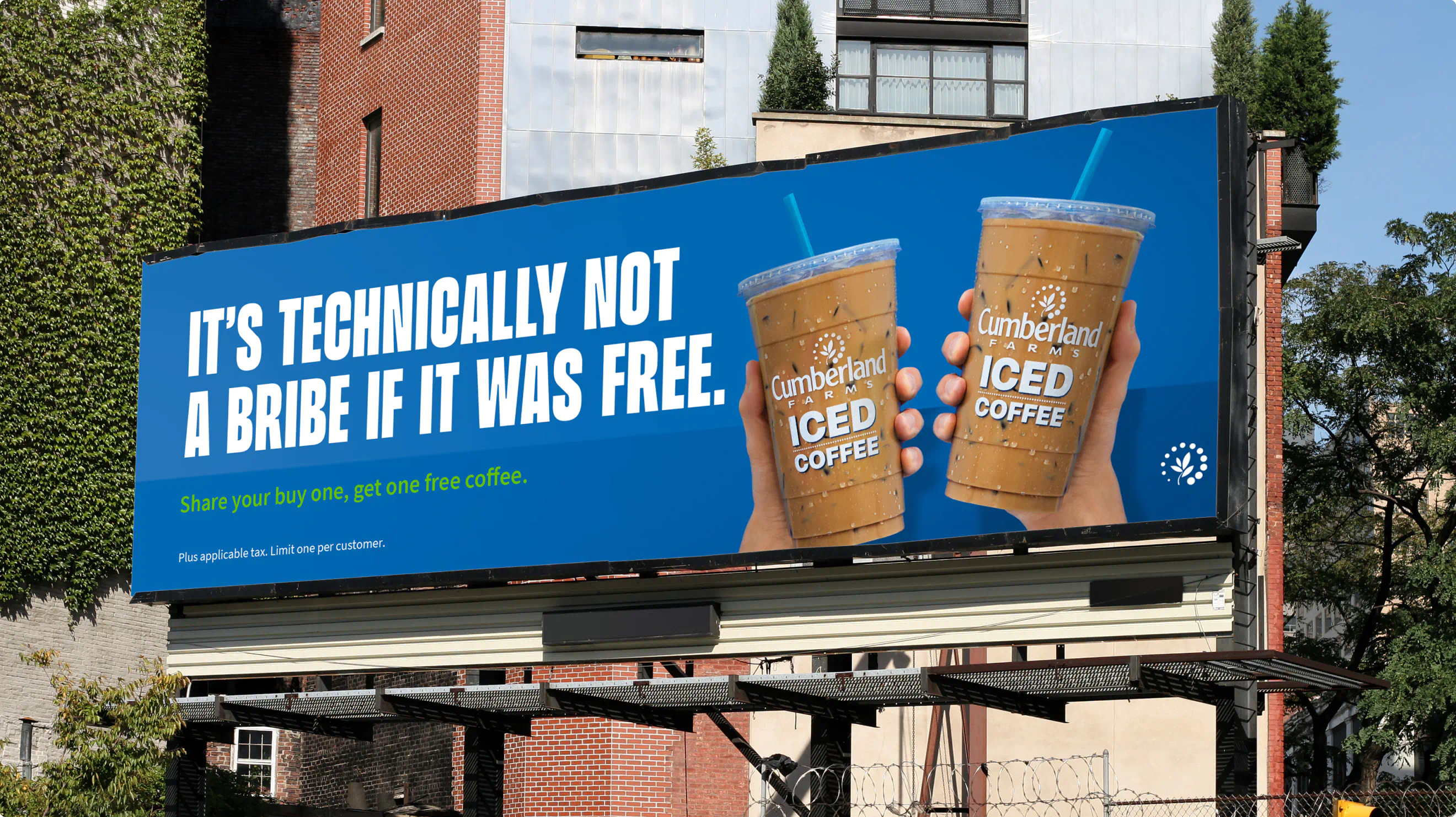 Cumberland Farms billboard. Blue background with two cups of iced coffee. The headline reads: "It's technically not a bribe if it was free."