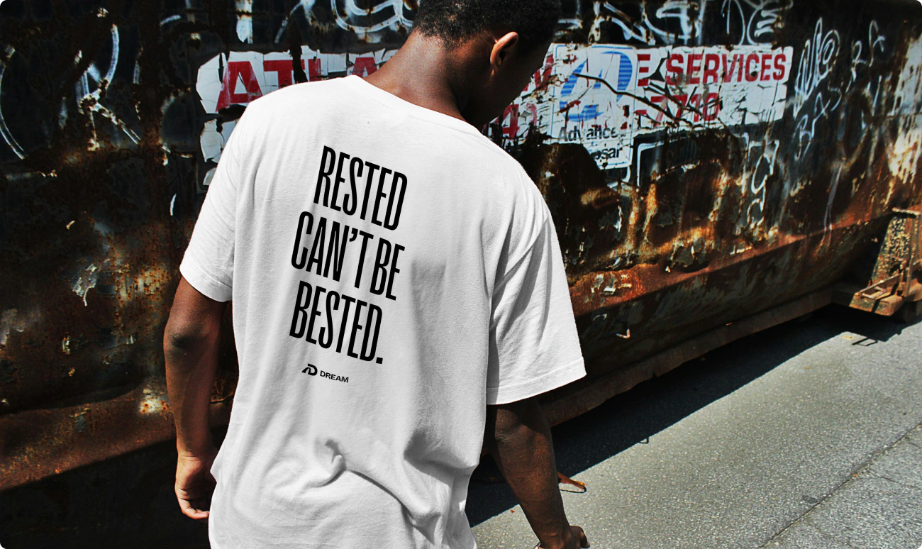 Merchandise and apparel design for Dream Performance. A white tshirt that reads: "Rested can't be bested."