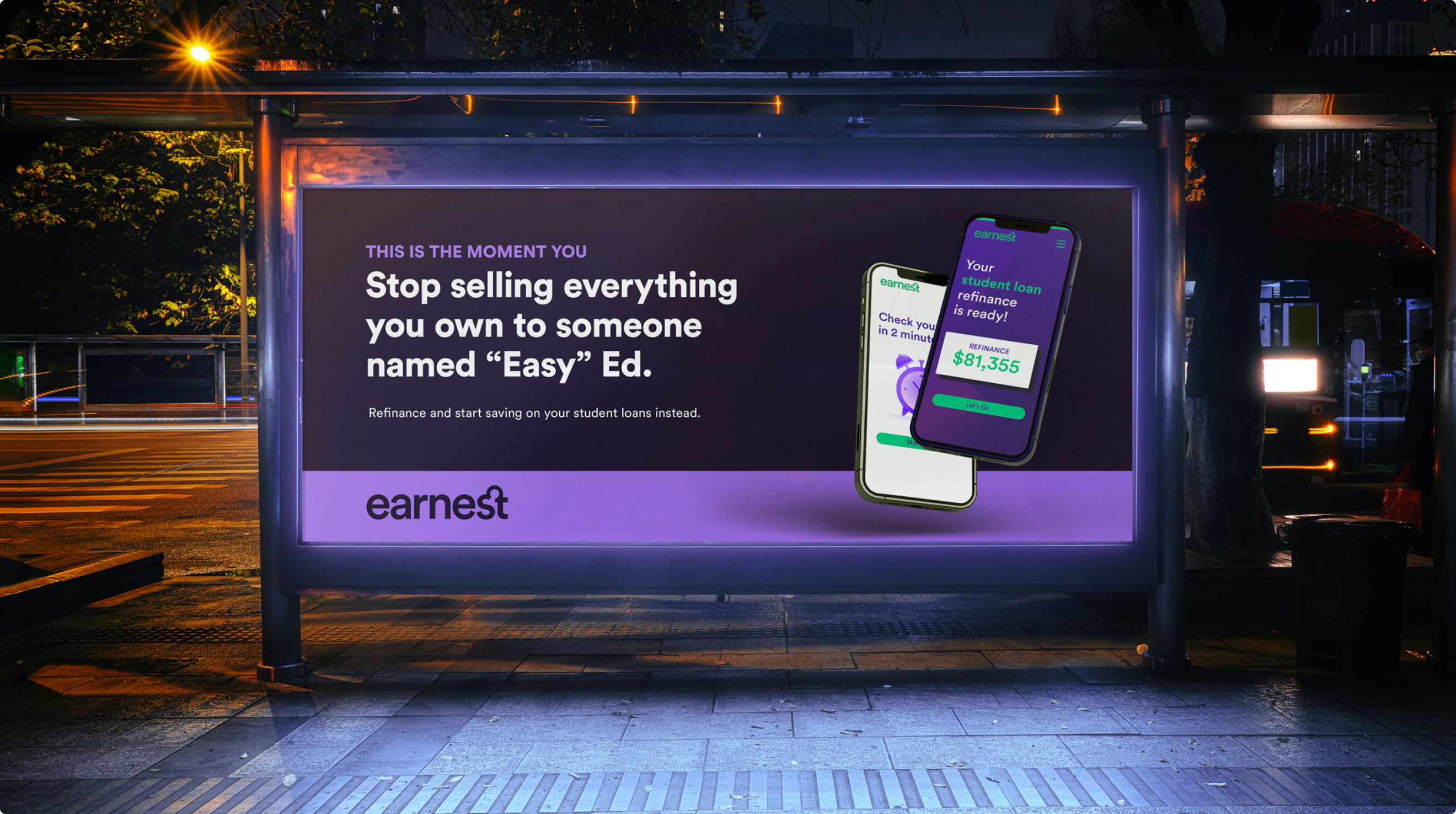 A sleek city billboard at night lit dramatically by a bus stop. The billboard has two floating cellphones with the earnest.com interface. the headline reads: "Stop selling everything you own to someone named Easy Ed."
