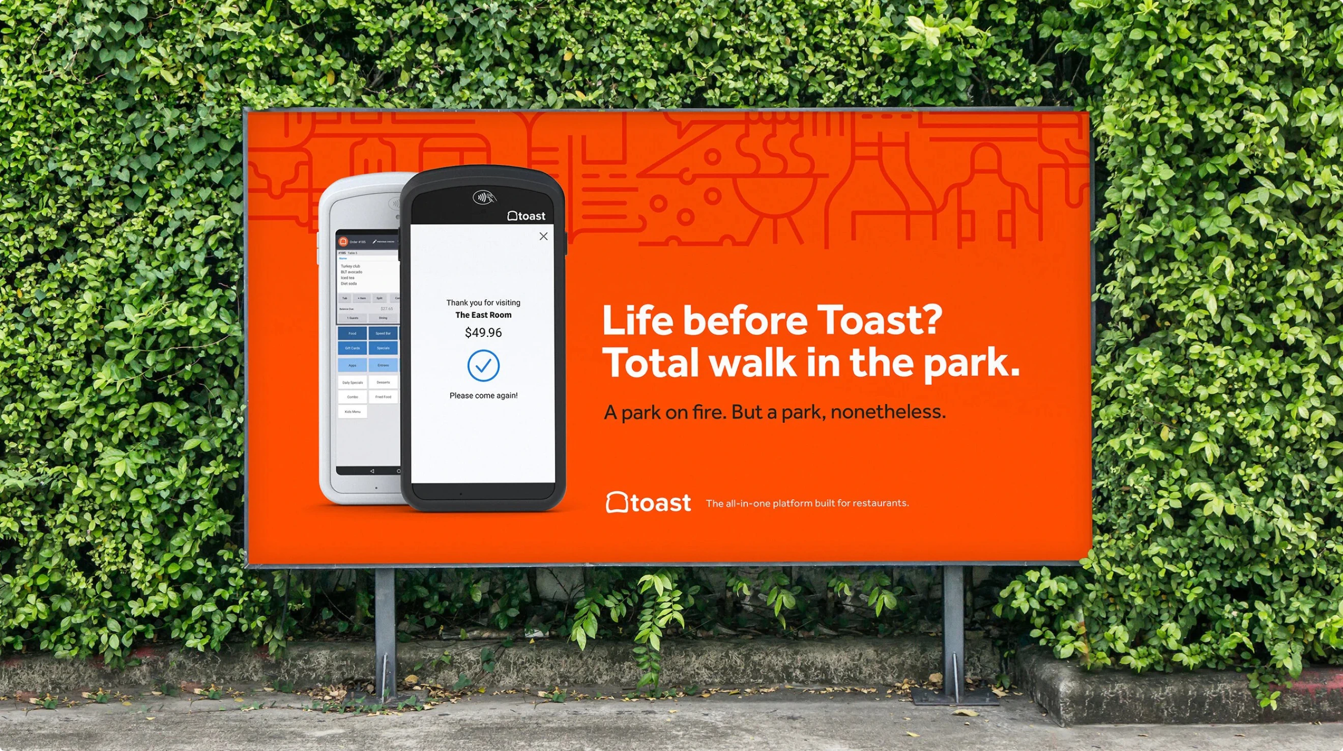 A bright orang billboard in the park for Toast. On it, we see two cell phones with the Toast app and interface. The copy reads: "Life before Toast? Total walk in the park. A park on fire. But a park, nonetheless."
