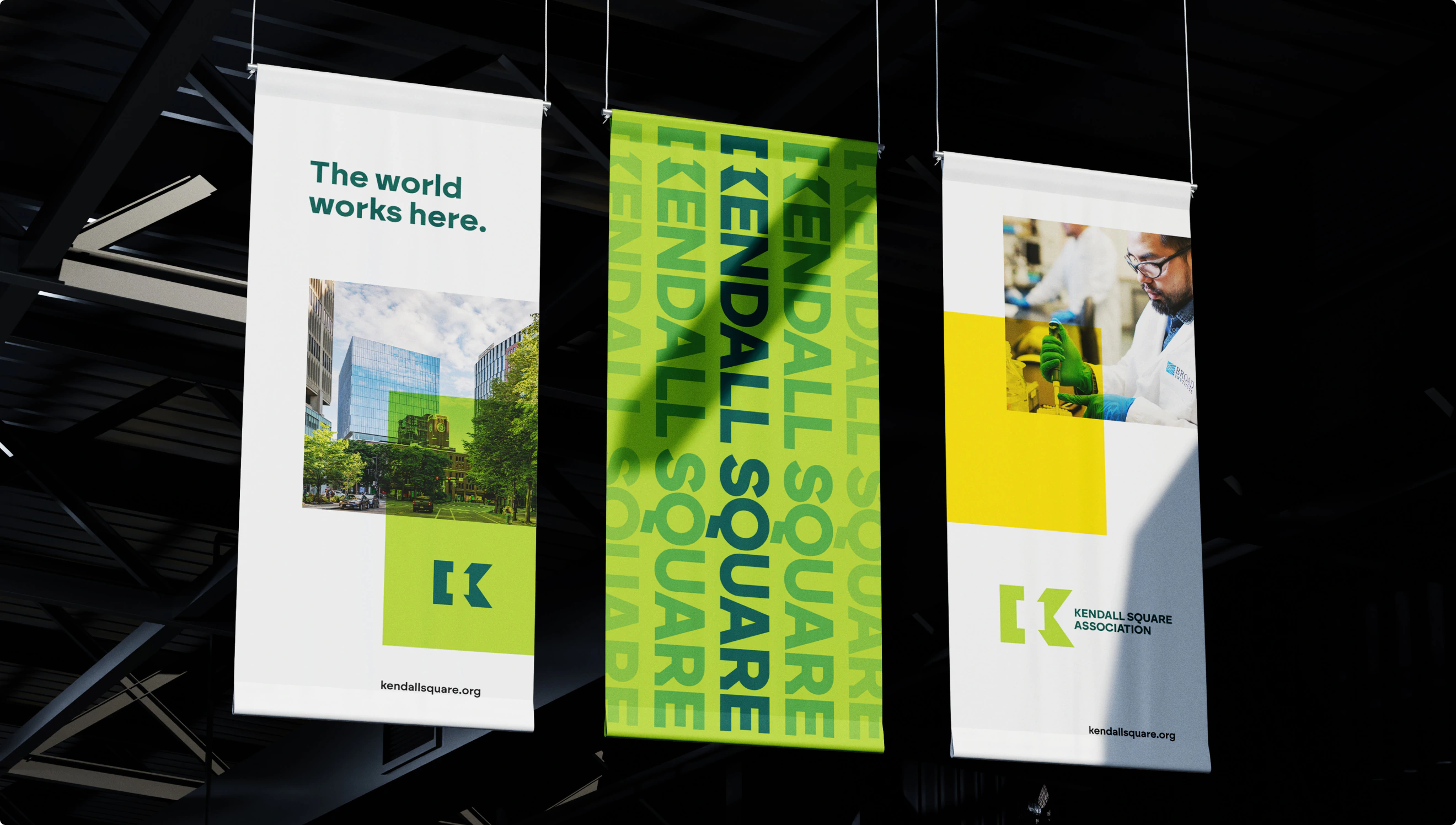 Three banners for the KSA hanging from the ceiling of a large building in Boston.