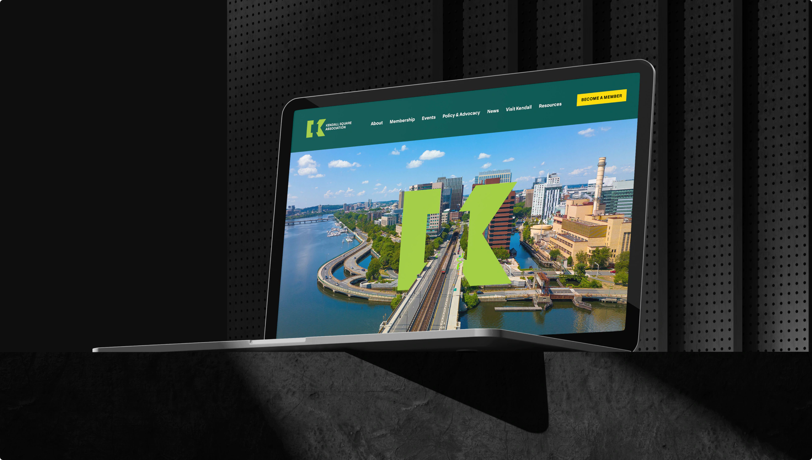 A laptop featuring a homepage design for KSA. Showing a hub of tech and innovation in downtown Boston.