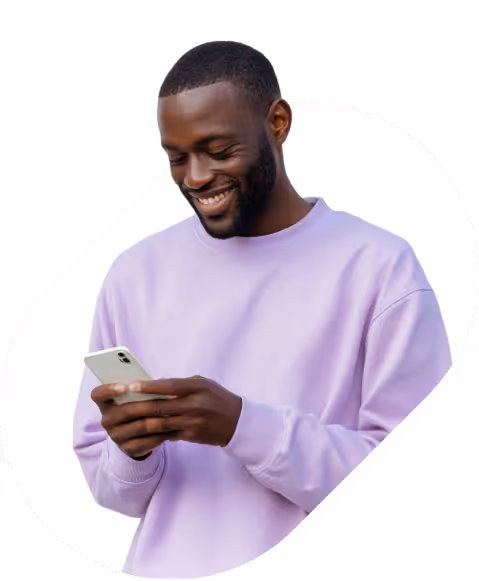Smiling man in a lavender sweatshirt using a smartphone, isolated on a white background with a rounded black frame.
