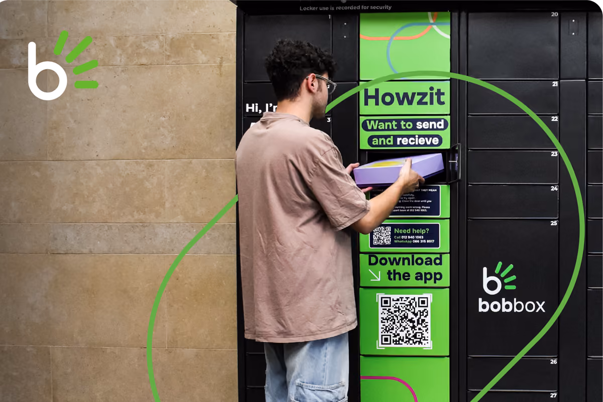 Person entering a code on a keypad of a black Bobbox parcel locker while holding a smartphone.