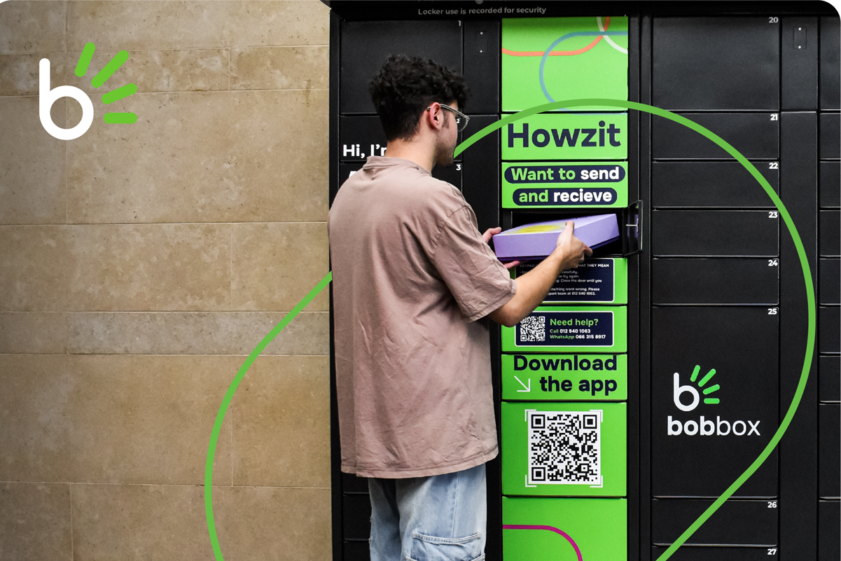 Person entering a code on a keypad of a black Bobbox parcel locker while holding a smartphone.