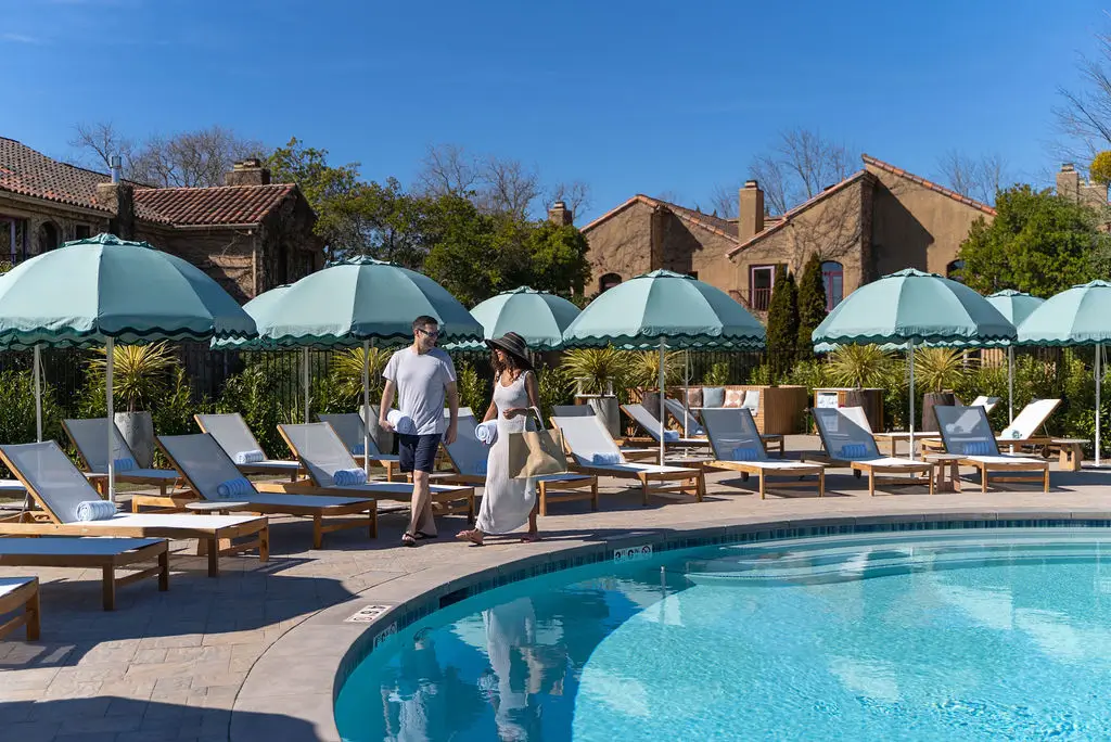 Guests walking past the pool and umbrellas at Vinarosa Resort & Spa