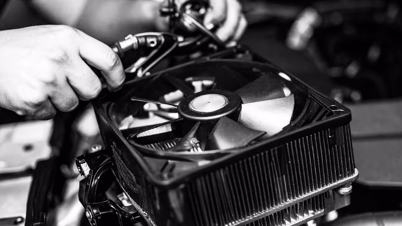 Technician inspecting engine cooling fan module during operation test — Cooper’s Garage cooling fan testing to verify proper function and airflow in European vehicles.