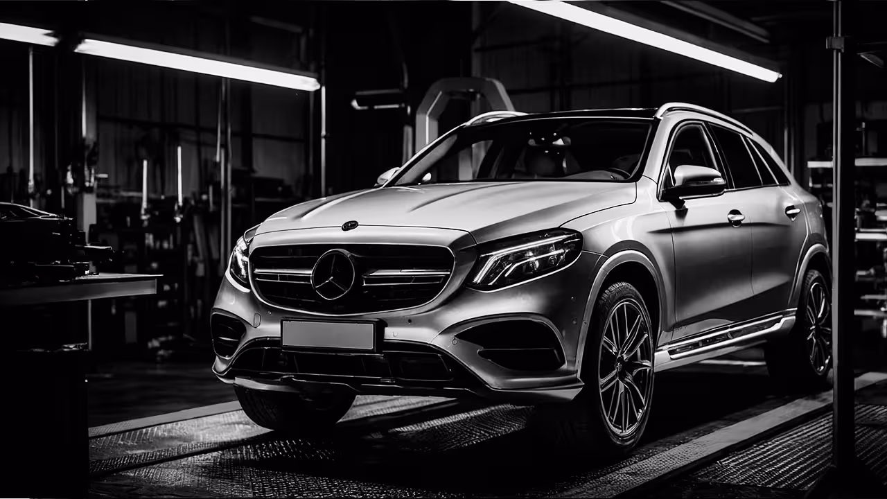 Mercedes SUV on alignment rack in service bay during full 4-wheel alignment.