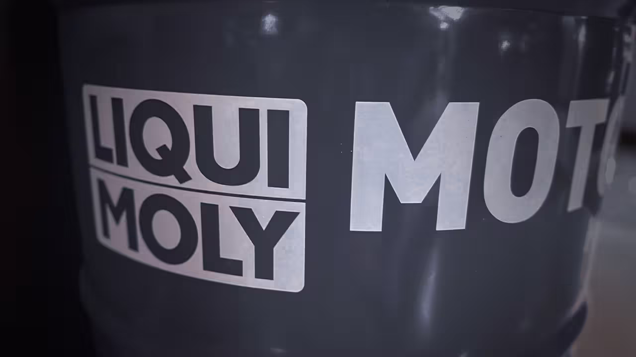 Close-up view of Liqui Moly oil additives and motor oils neatly arranged on a black shelving unit at Cooper’s Garage.

