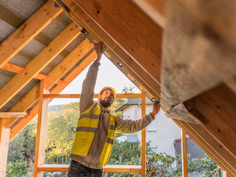 A specialist performs technical maintenance and inspects the roof's condition.