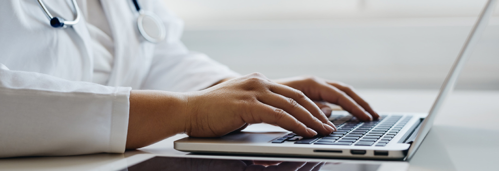 doctor's hands on laptop