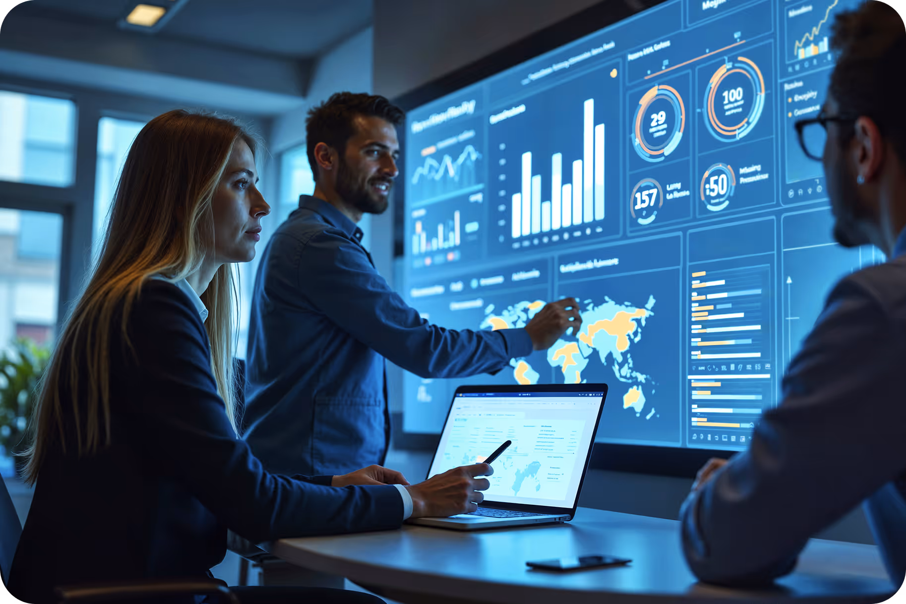 Two people leaning over a desk pointing at a laptop screen and papers.